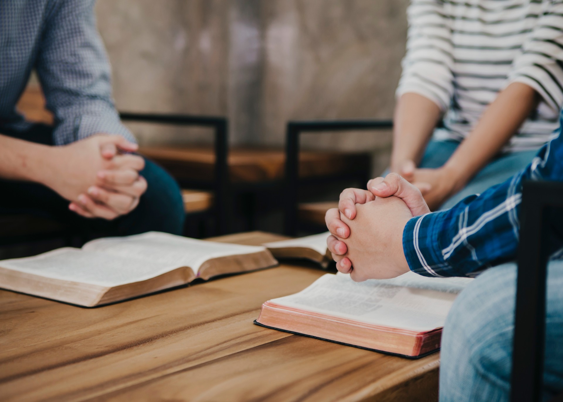 group of christian  sitting around wooden table